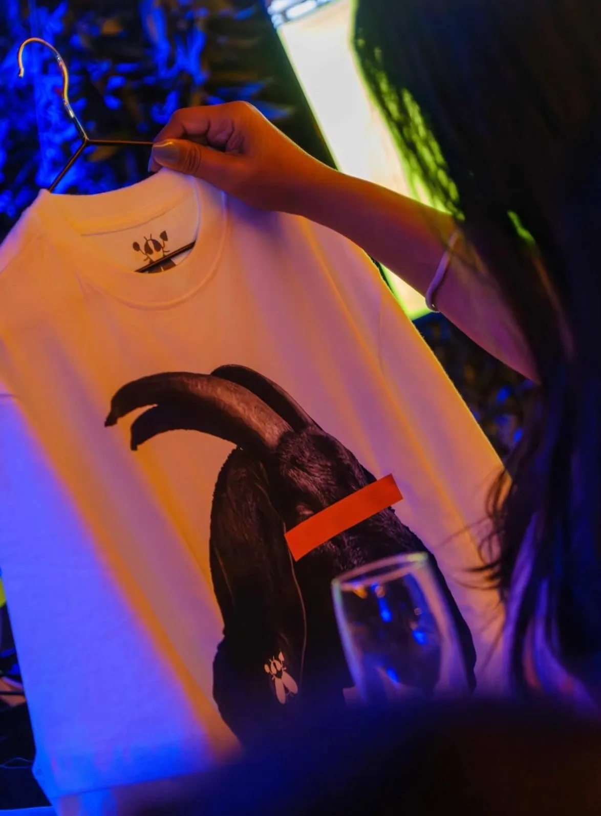 An Imbuzi tee held up at a Sacxess event